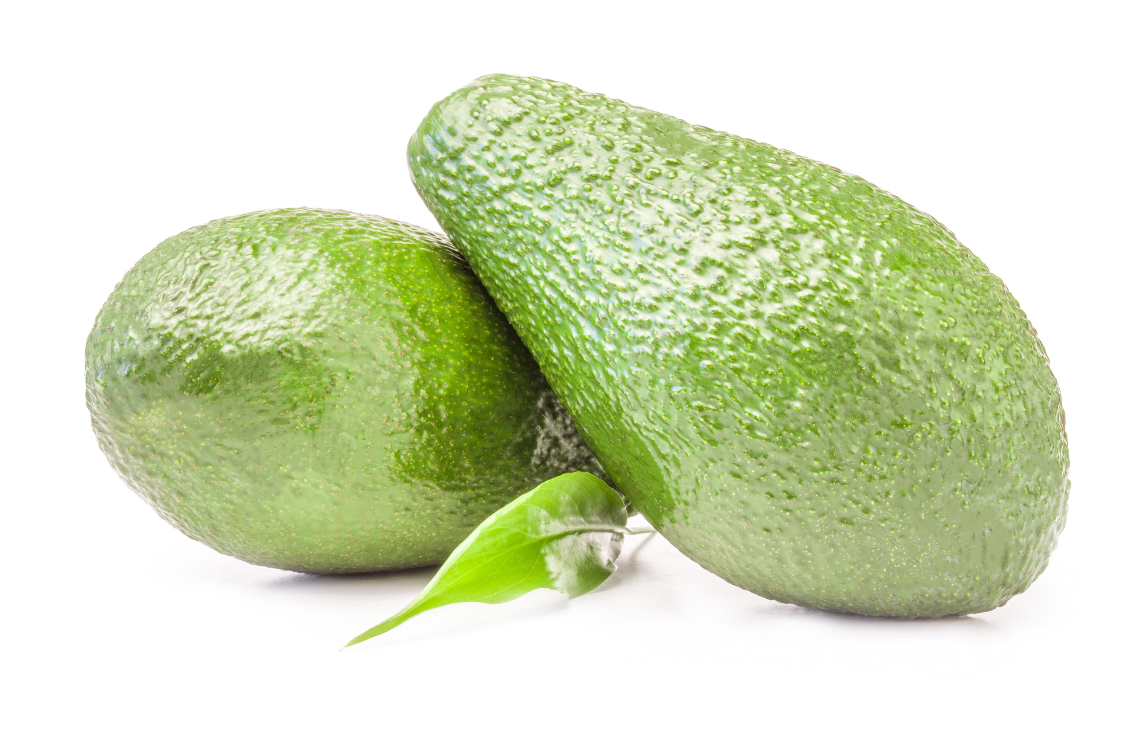 Two ripe avocados with a green leaf.