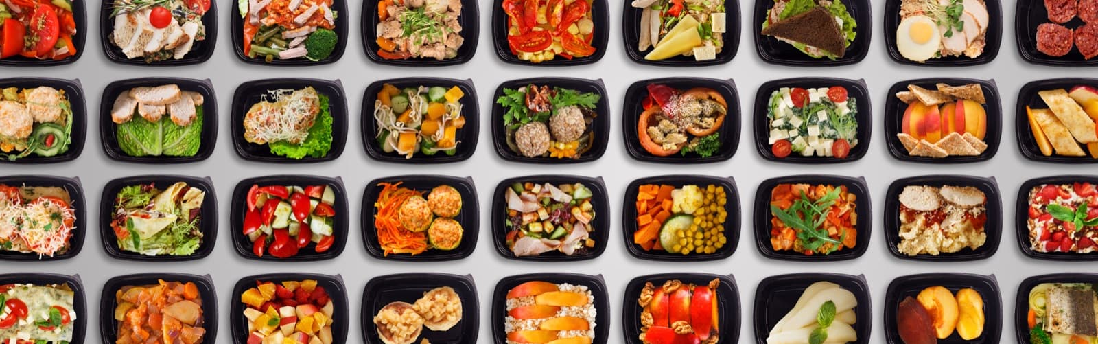 Rows of portioned meal-prep containers filled with lean proteins, vegetables and fruit.